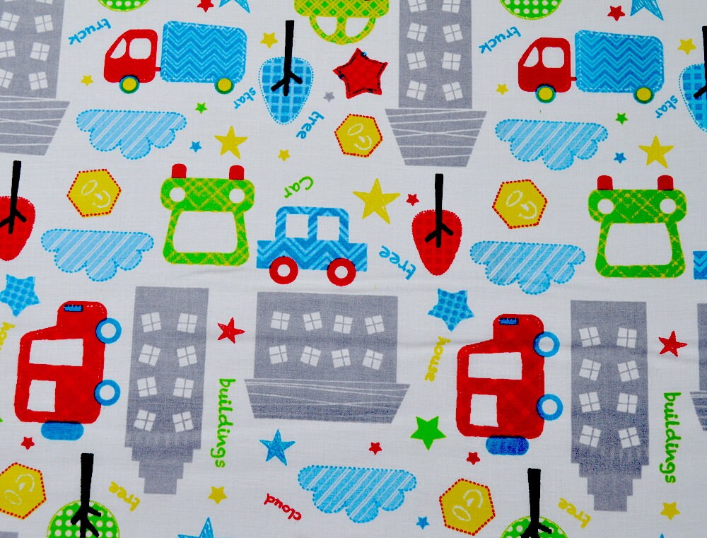 White cotton fabric covered with cars, trees, trucks and buildings.