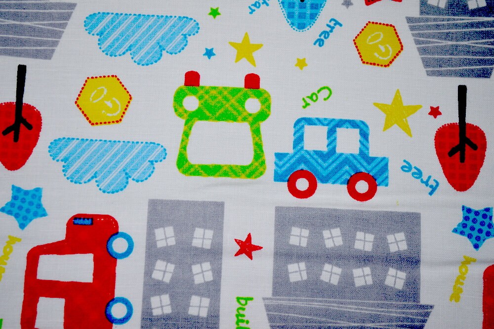 Close up of cars, trucks, clouds and buildings.