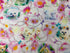 This cat fabric is called kitty glitter and has several different breeds of cats and flowers on a white background.
