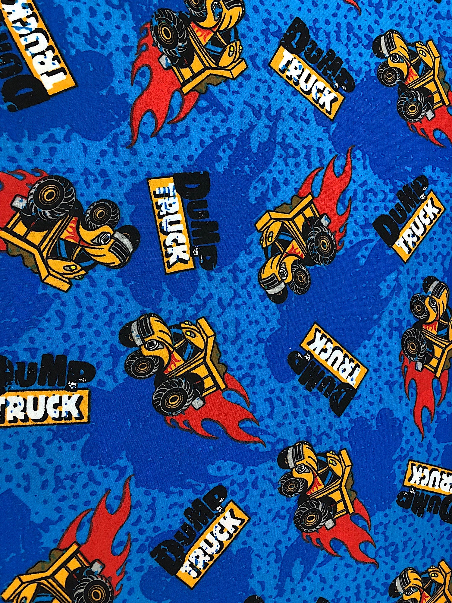 This fabric is called Kids Time Blue and has dump trucks scattered all over a blue background