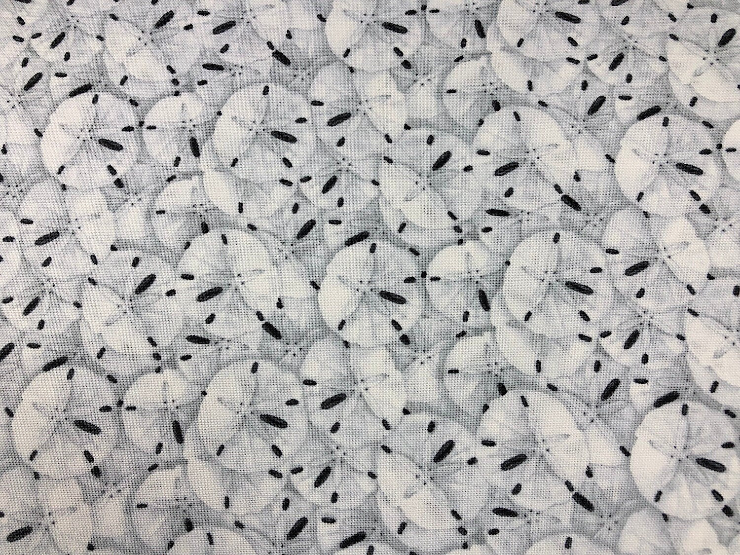 This fabric is covered with sand dollars.