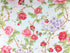 This fabric is called Morning in the Garden and has various shades of pink roses and green leaves on a light blue background.