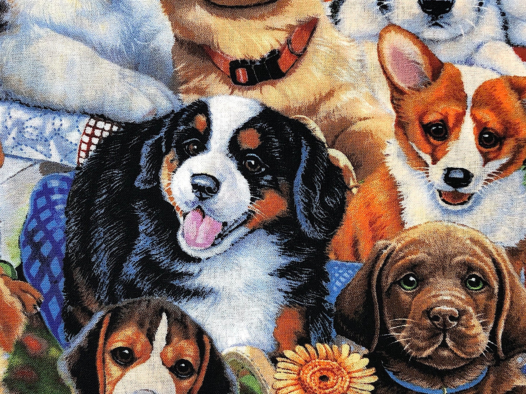 This fabric is called Garden Puppies and has several different breeds of dogs in a garden.
