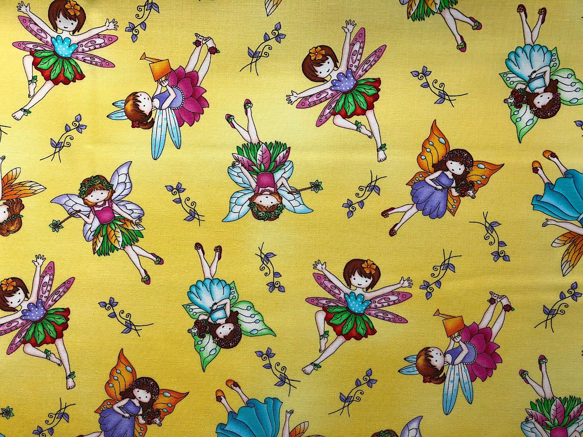 This fabric is called Fairy Land and has girl fairies on a yellow background.