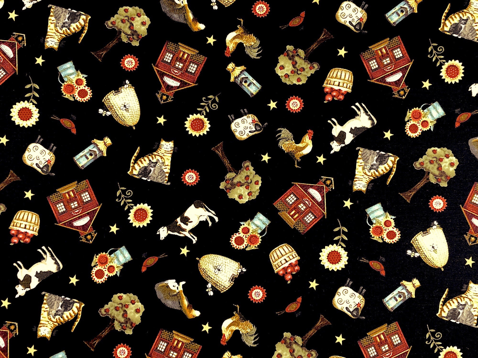 This fabric is called Count Your Blessings and is covered with cows, sheep, flowers, birds apples, bees dogs trees and more. The background is black.