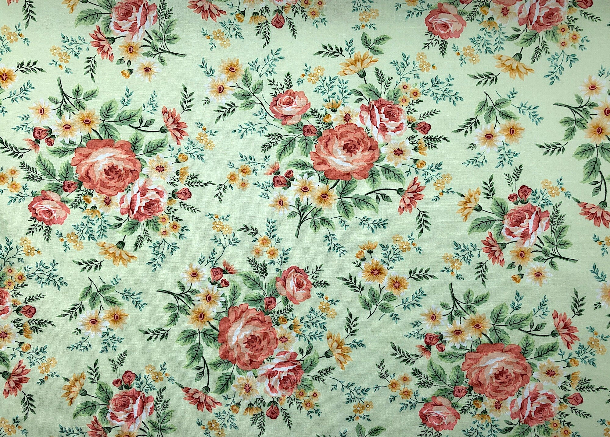 This fabric is called Spiced Garden and is covered with flowers and leaves. The flowers are shades of peach and yellow