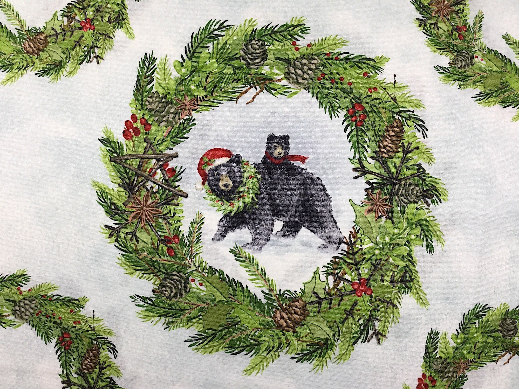 This fabric is covered with winter scenes of animals in wreath circles. There are fox, bears, snow bears, and deer within the decorated wreaths.