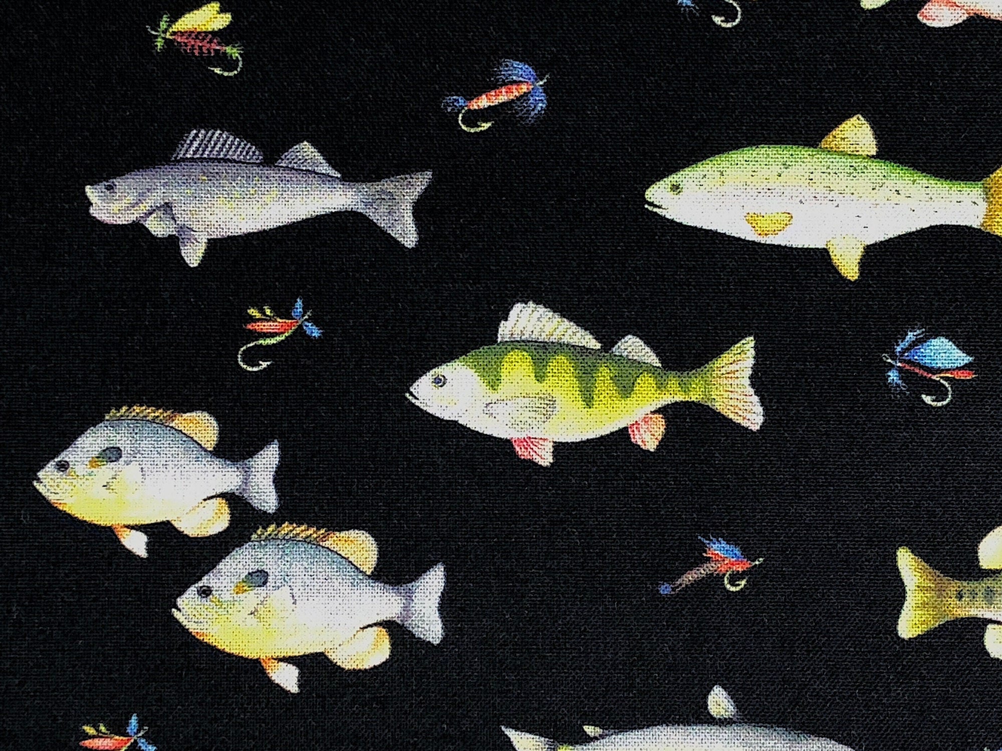 This fabric is called Go Fish Black and is part of the Keep It Reel collection. It is covered with various fish and fishing flies.