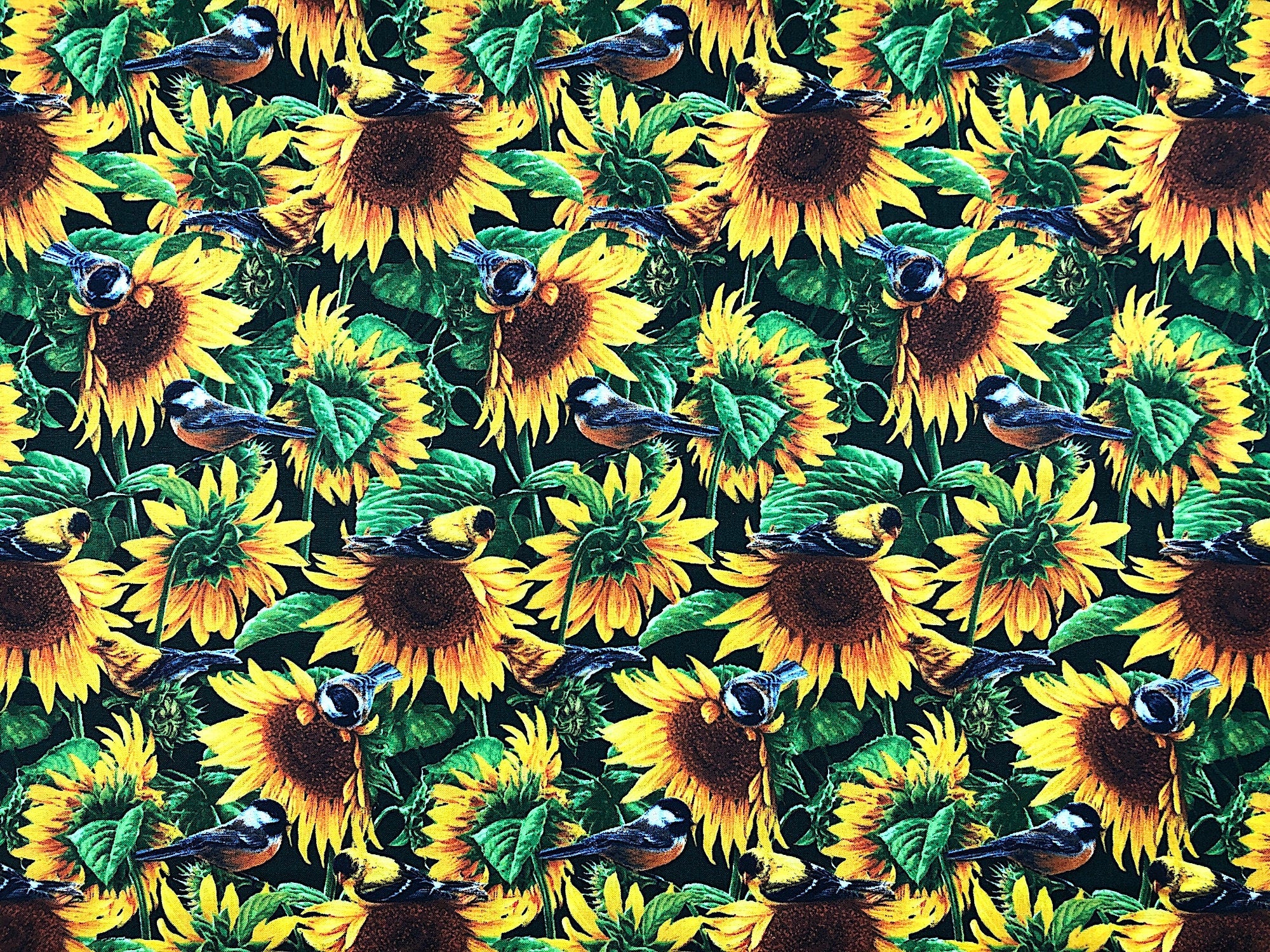 This fabric is covered with sunflowers, leaves and birds.