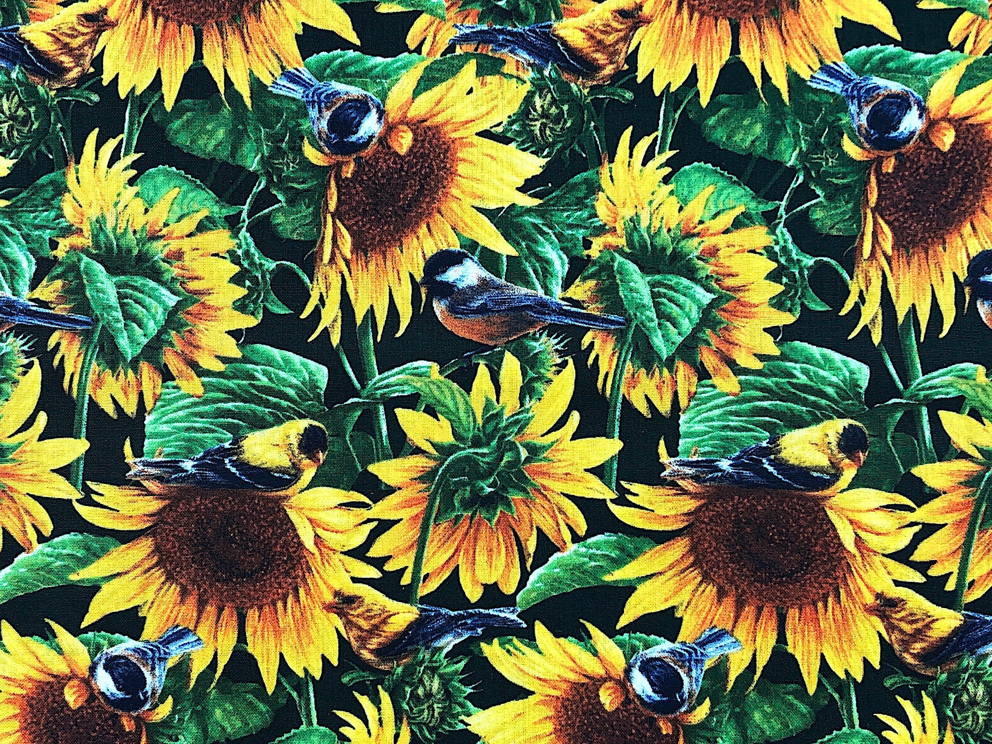This fabric is covered with sunflowers, leaves and birds.