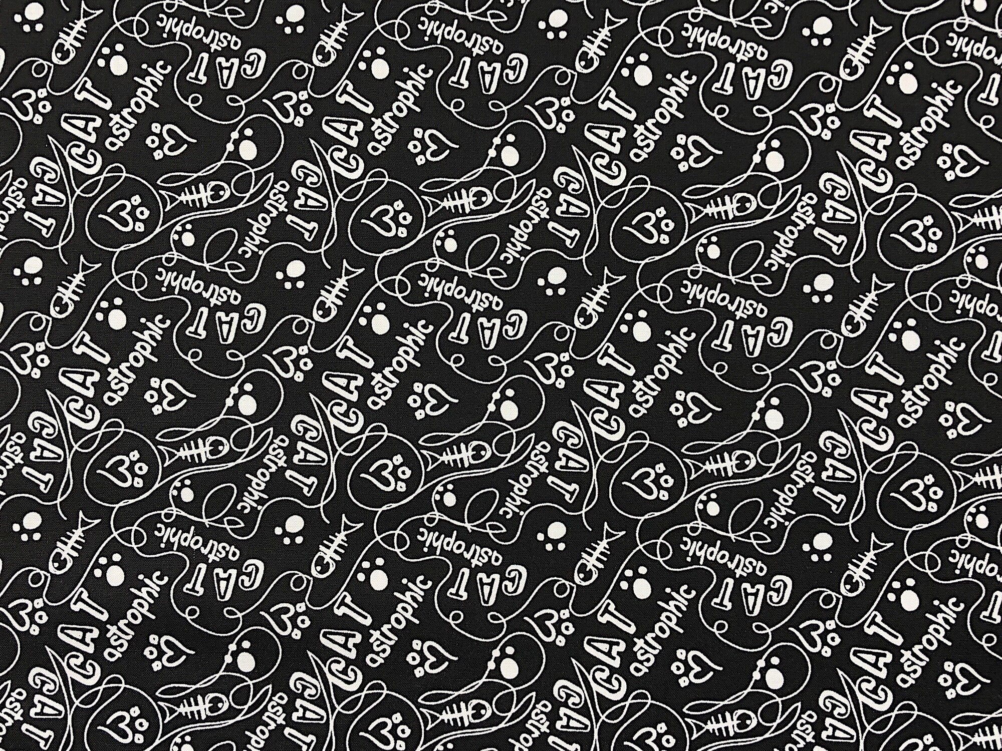 This Black fabric is called Cats Rule - Catastrophic. White words fish bones and heart prints are tossed all over this fabric.