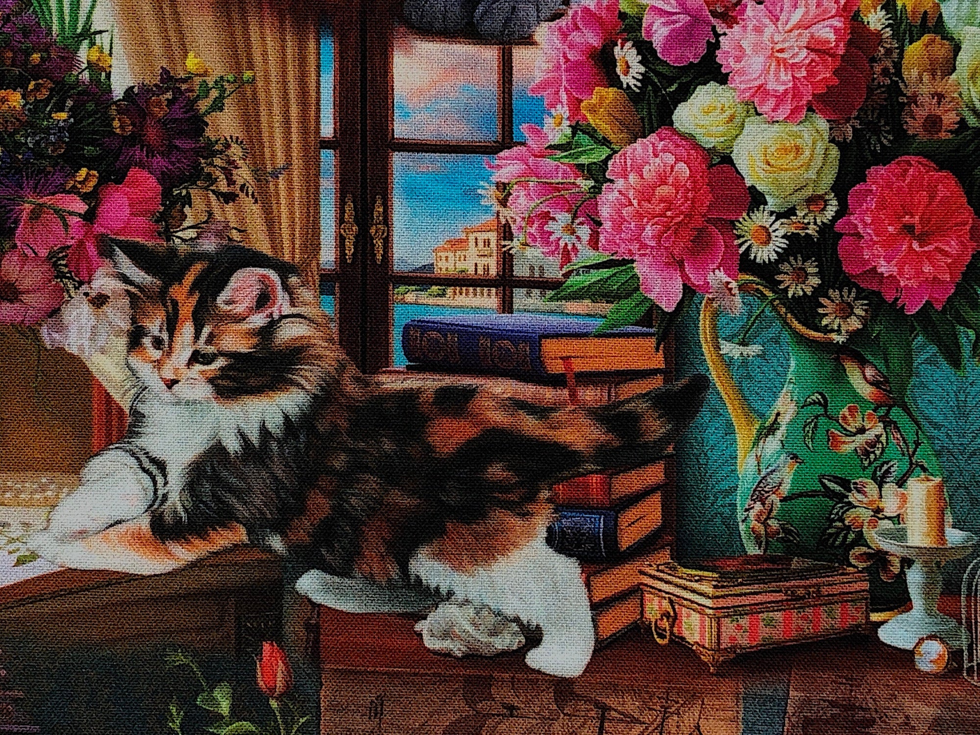 Close up of a calico cat by a vase of flowers.