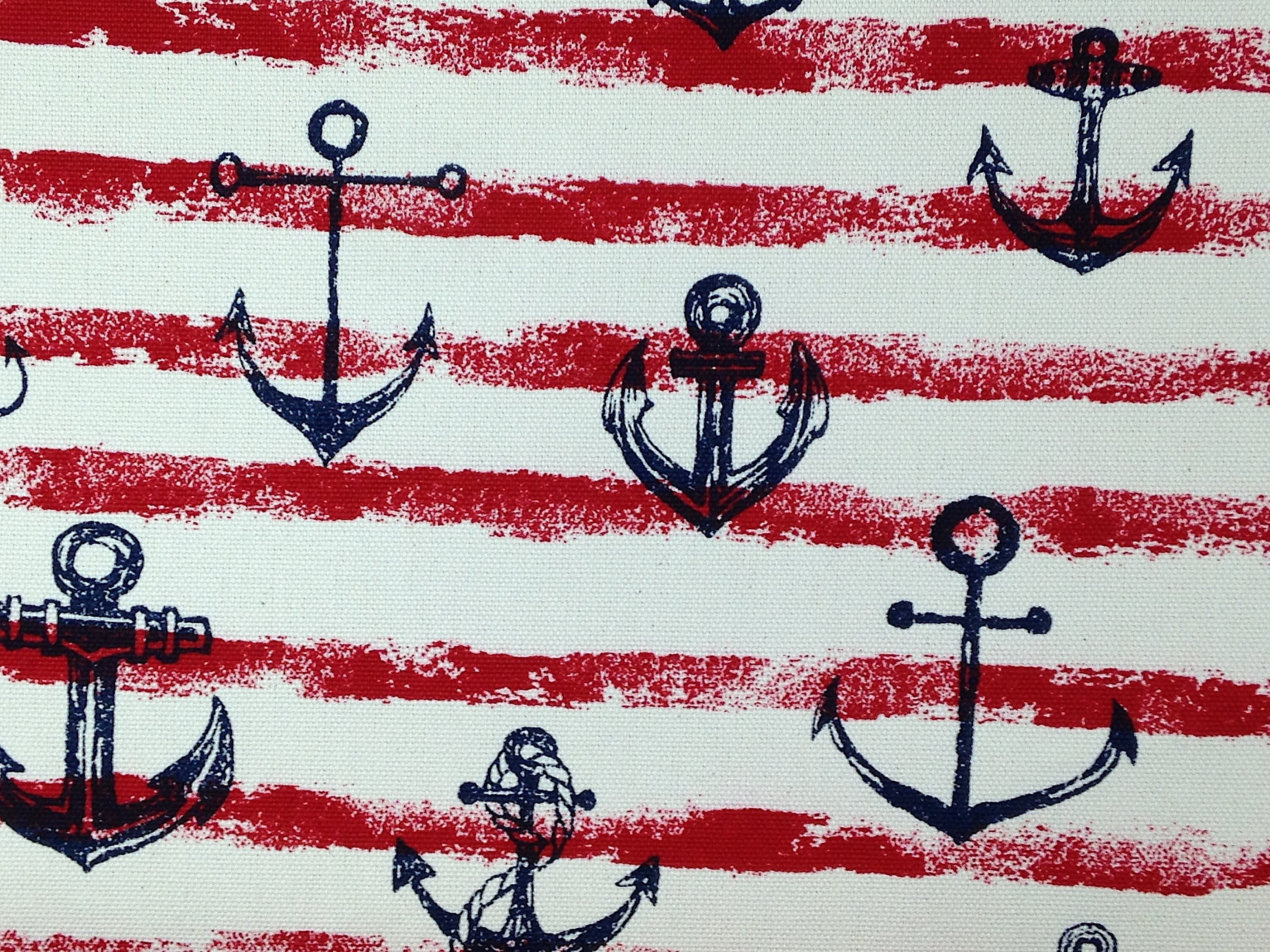 Blue anchors and red stripes on a cream background and is called Anchor Canvas. This is a heavy canvas fabric, perfect for throw pillows.