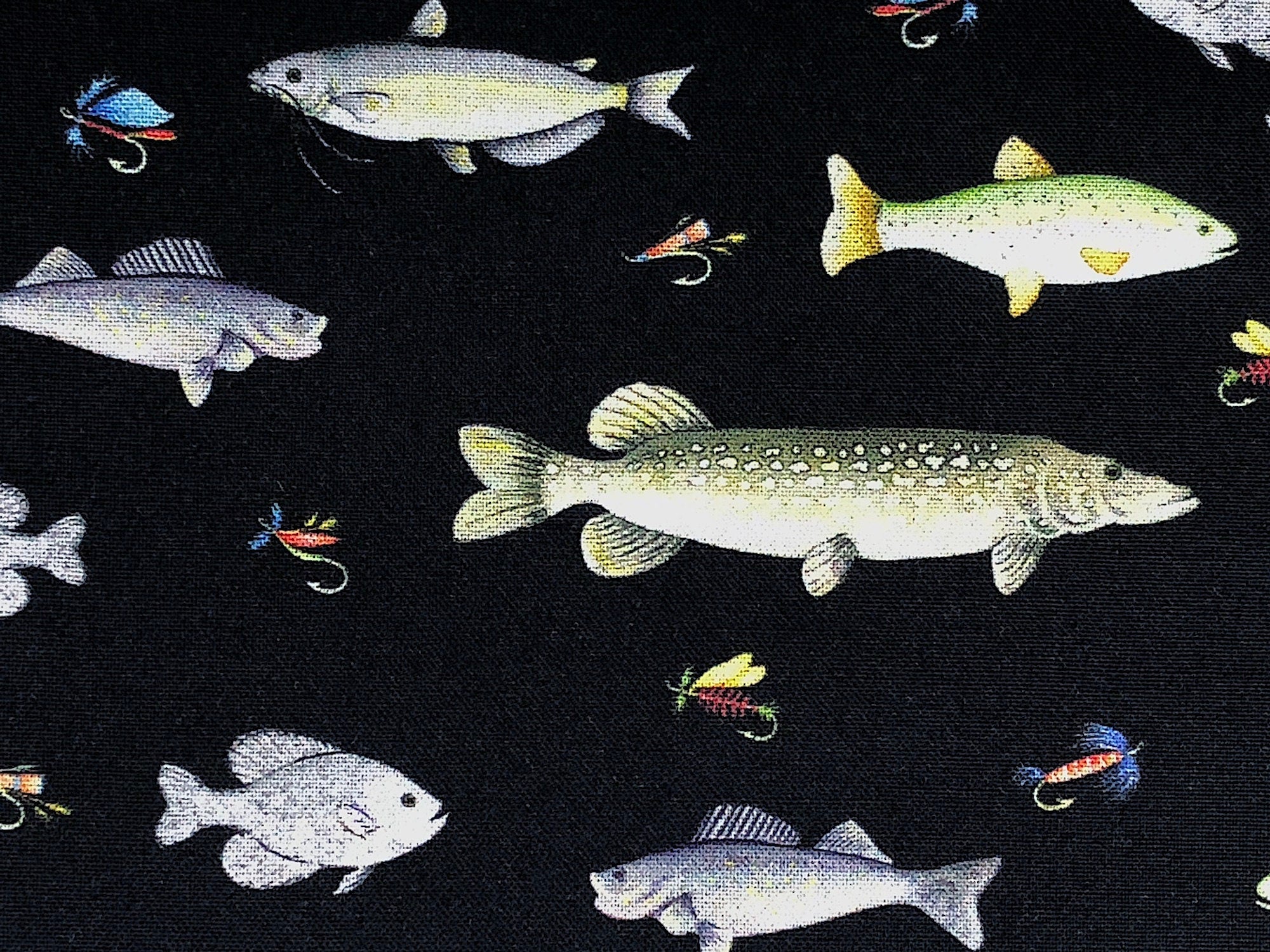 This fabric is called Go Fish Black and is part of the Keep It Reel collection. It is covered with various fish and fishing flies.