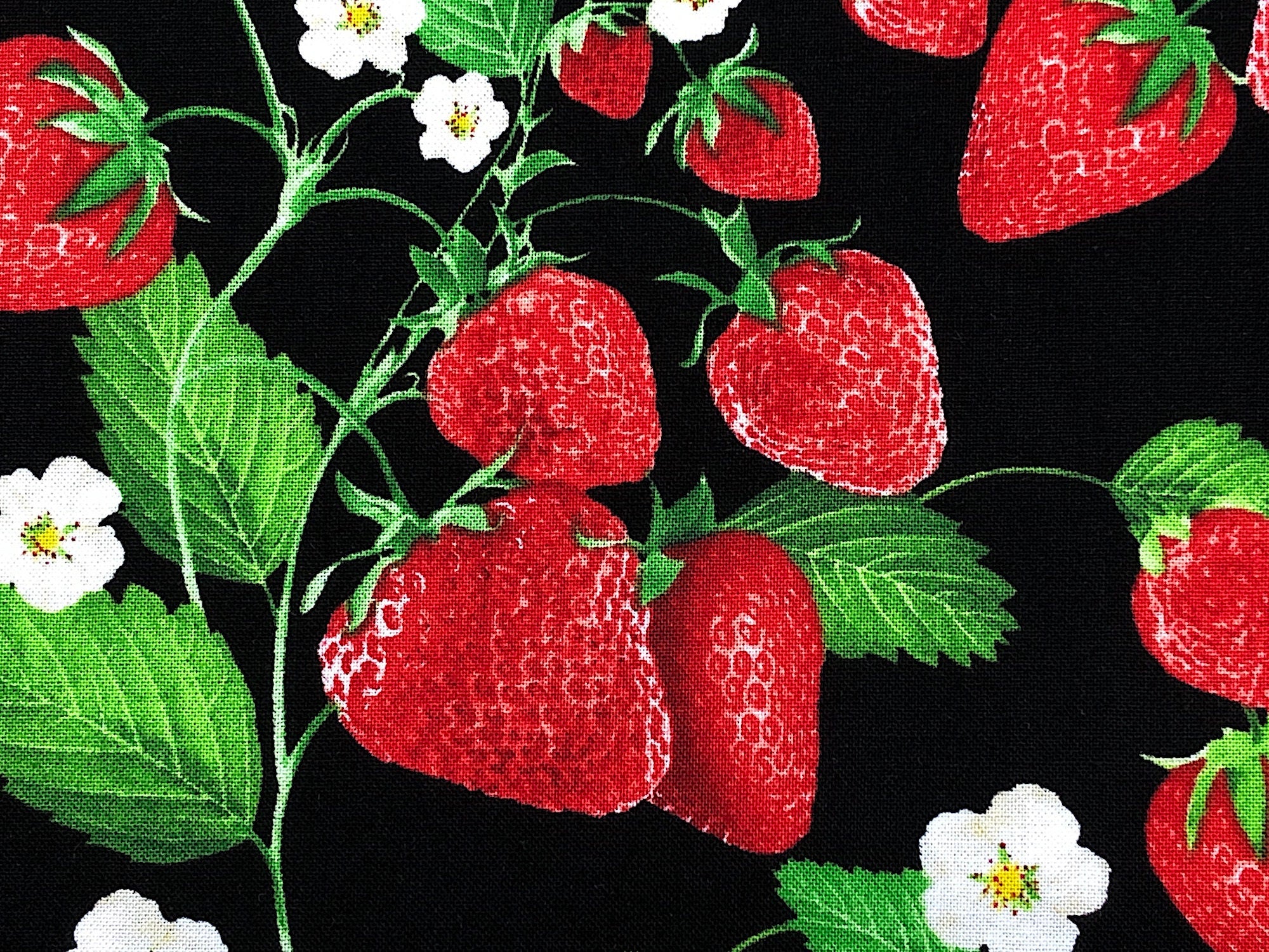 Close up of strawberries, leaves and flowers.