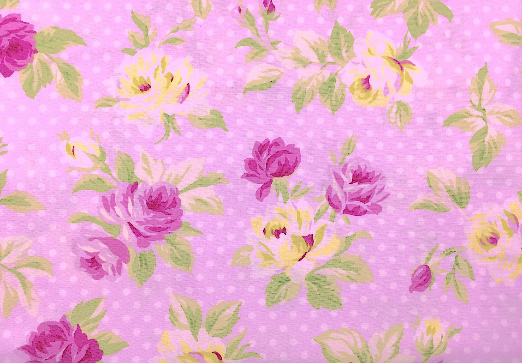 This fabric is called Sunshine and is covered with Pink and White Flowers The Background is pink with white dots.