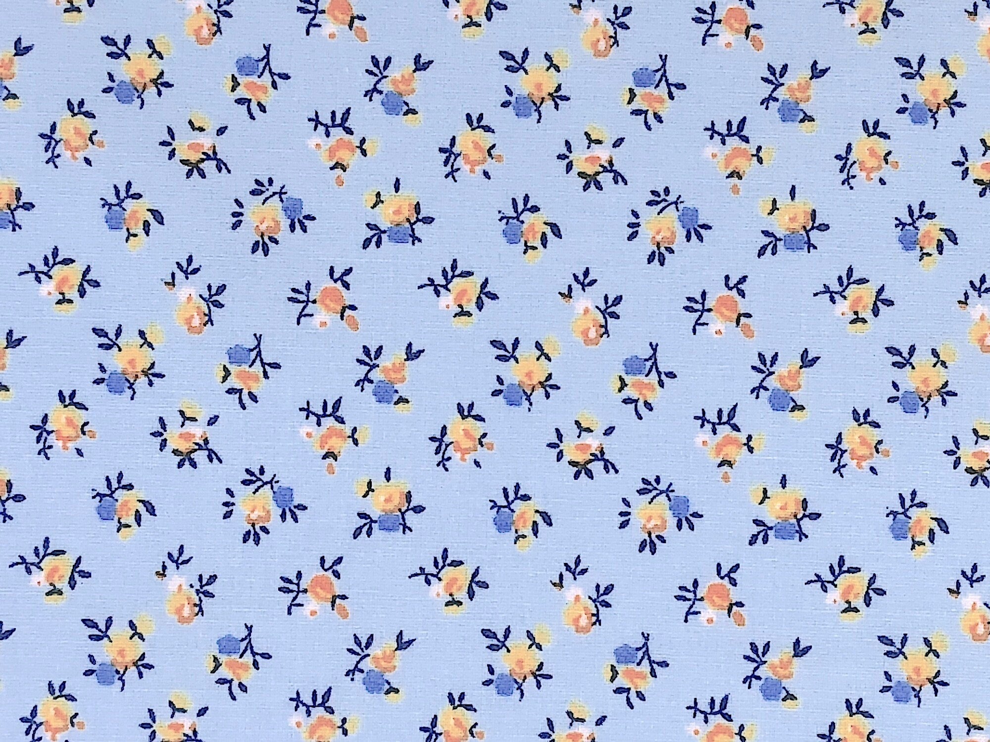 This light blue fabric is covered with small yellow flowers