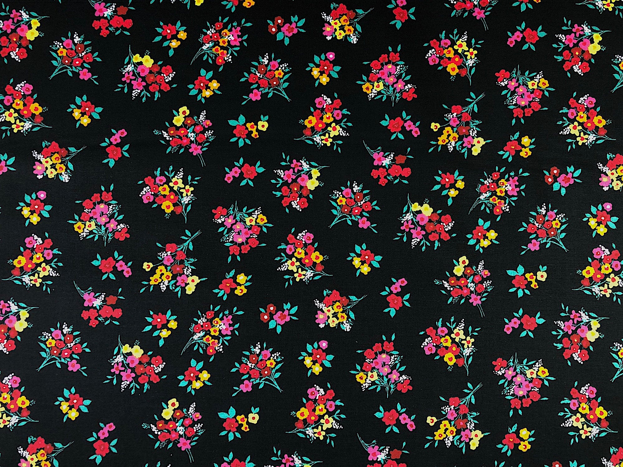 Black cotton fabric covered with bouquets of flowers.