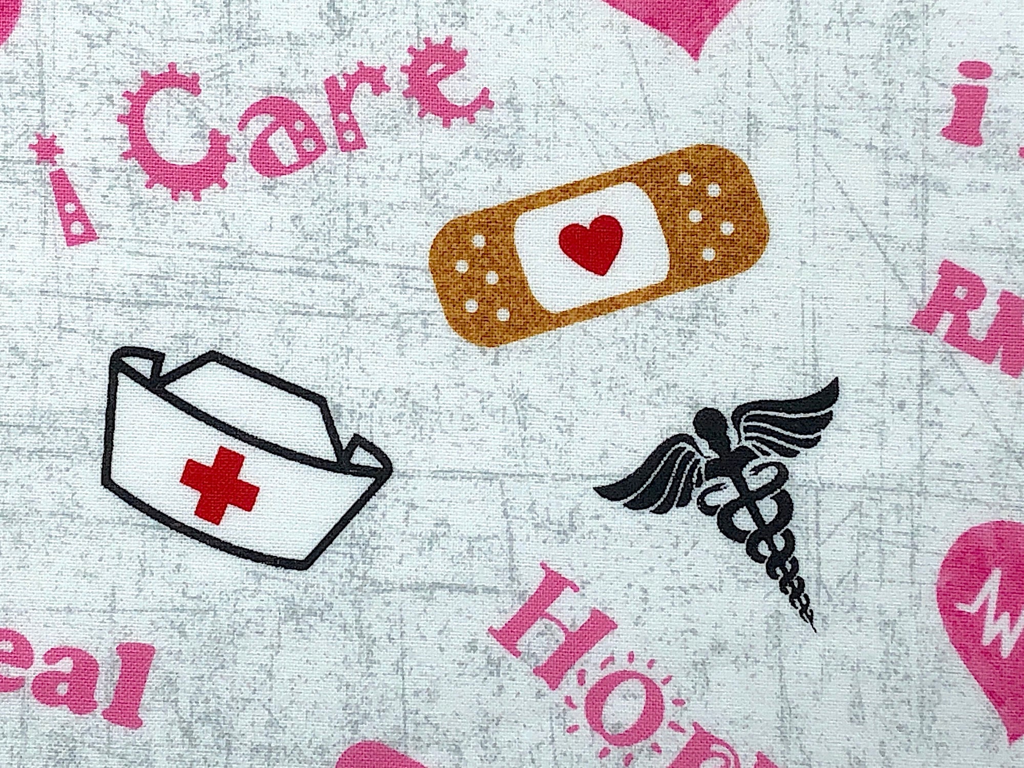 Close up of a nurse emblem, nurse cap and band-aid.
