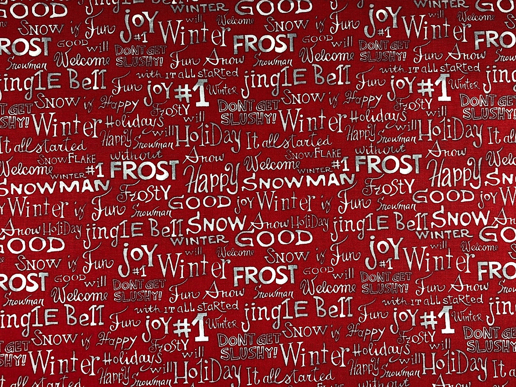This fabric is covered with rows of winter sayings on a red background. Some of the words are: Joy, Winter, Frost, Jingle Bells, Fun, Snowman, Welcome and more.