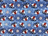 This Patriotic fabric is covered with hearts and stars. The hearts resemble a flag. The background looks like wood siding that is blue.