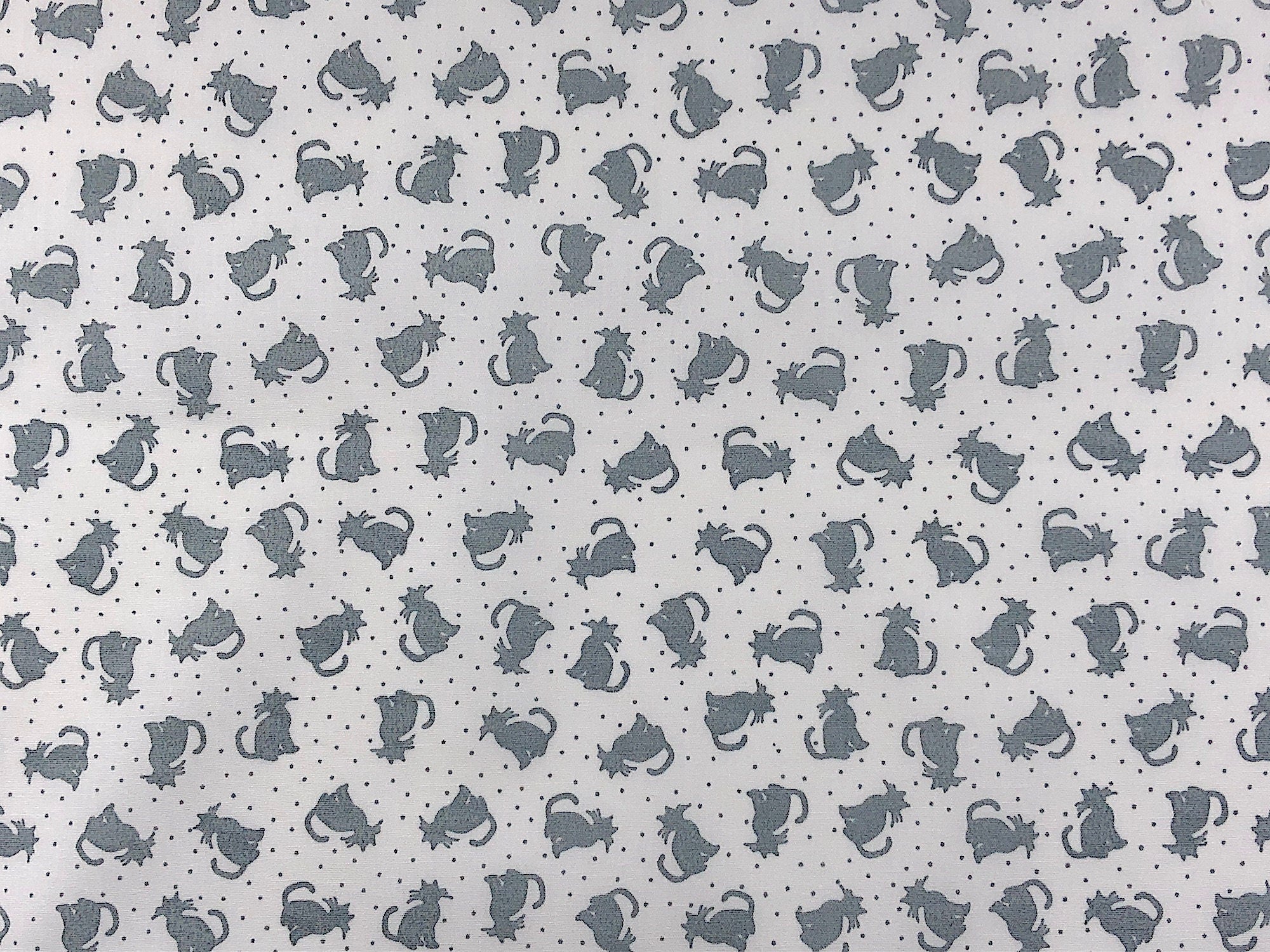 Grey cats on a white background that also has small grey dots.