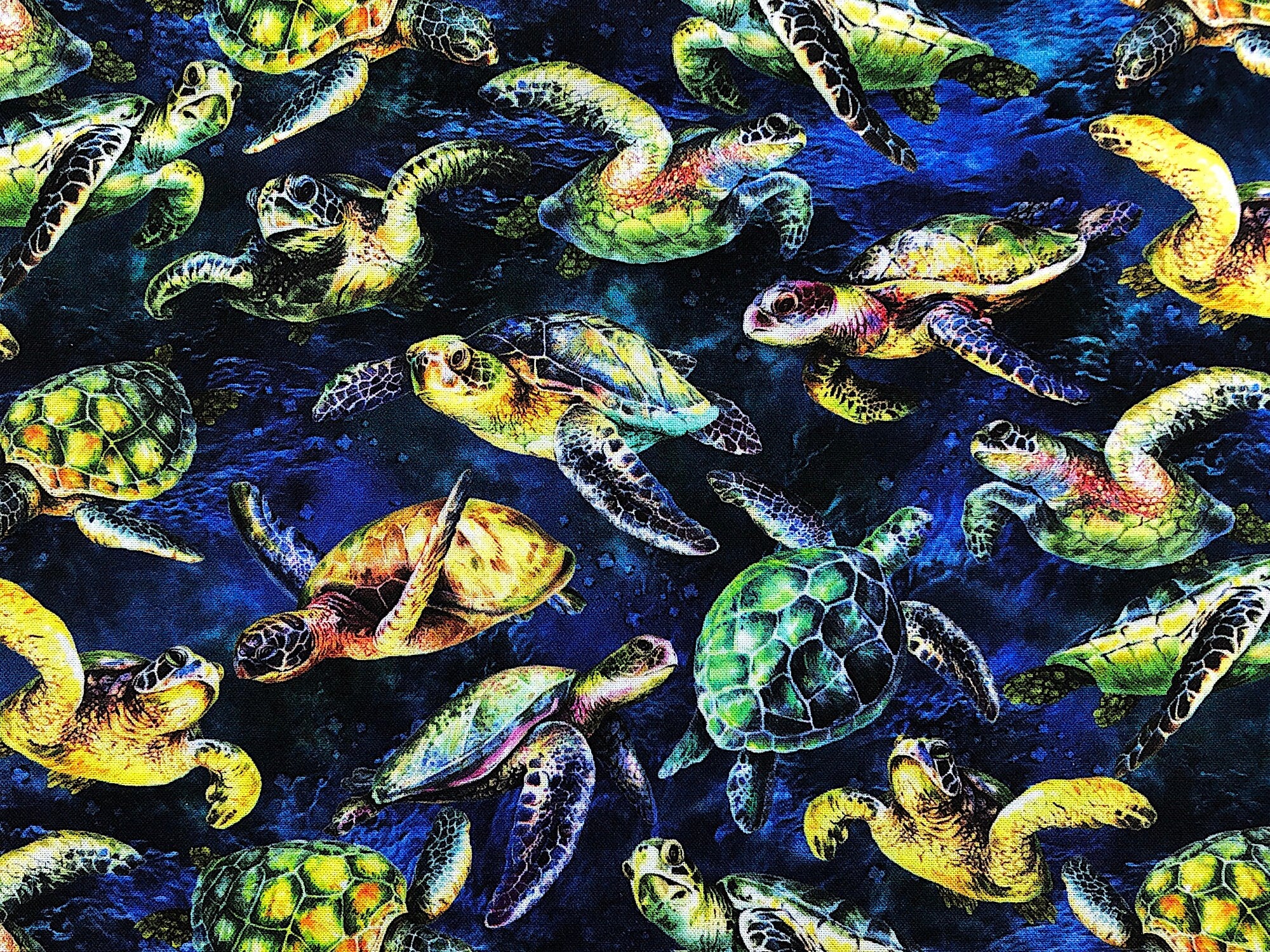 This fabric is part of The Reef collection and is covered with swimming sea turtles.