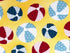 Close up of yellow cotton fabric covered with beach balls.