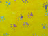 Close up of paw prints on yellow fabric.