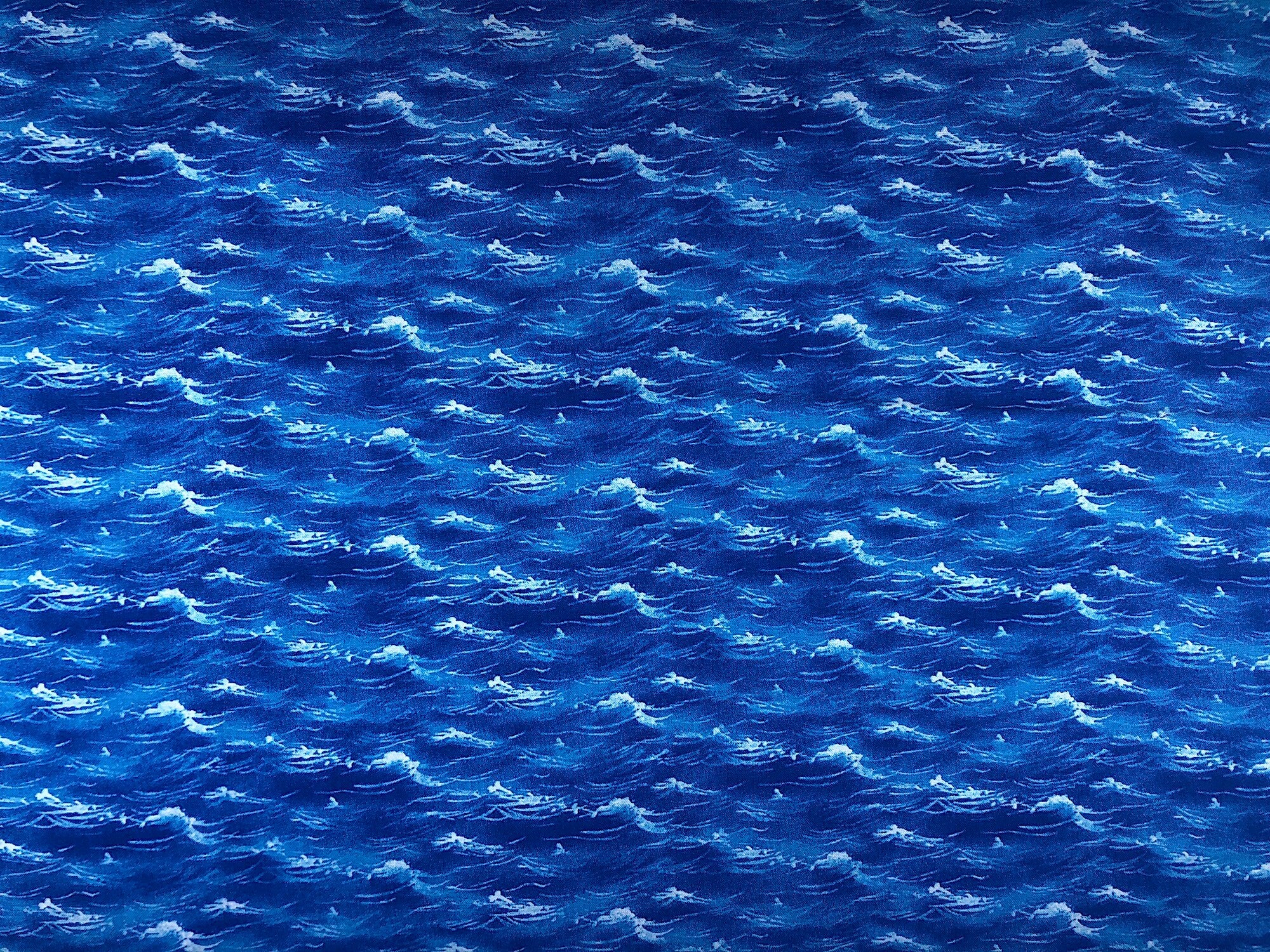 This blue fabric has white peaks as if you are looking out over the water.
