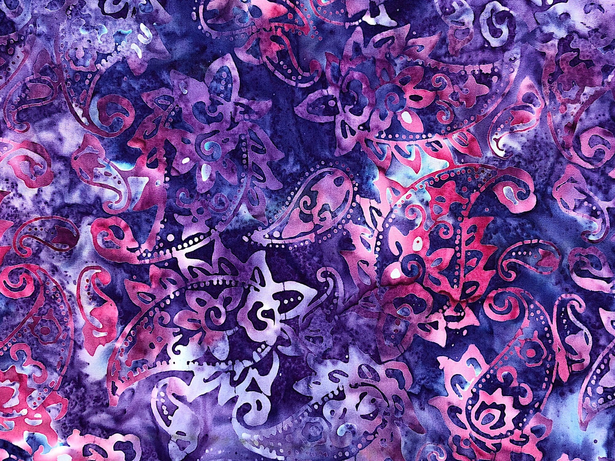 Close up of pink and purple batik fabric.