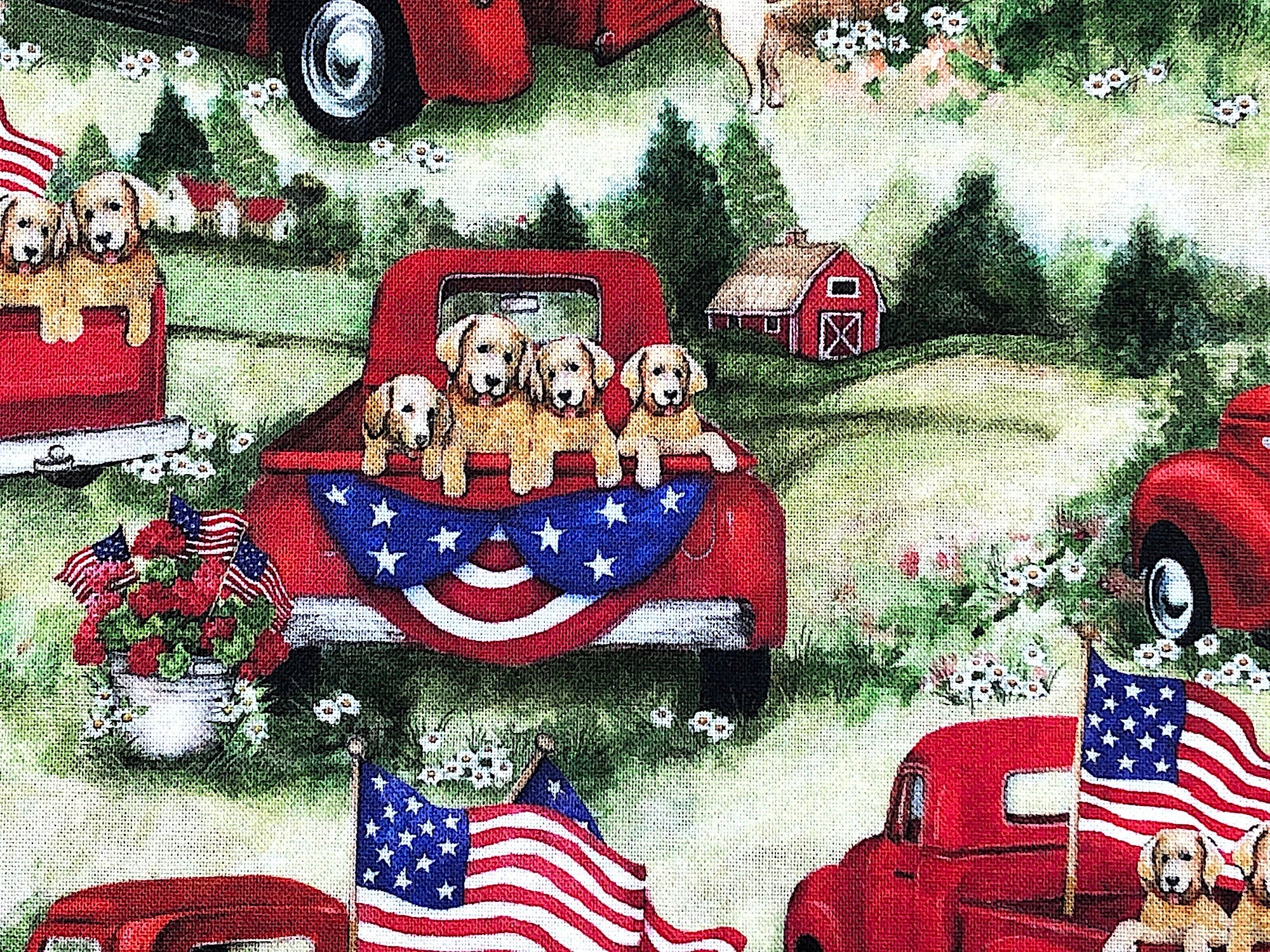 Close up of dogs in the back of a red truck that is in a field 