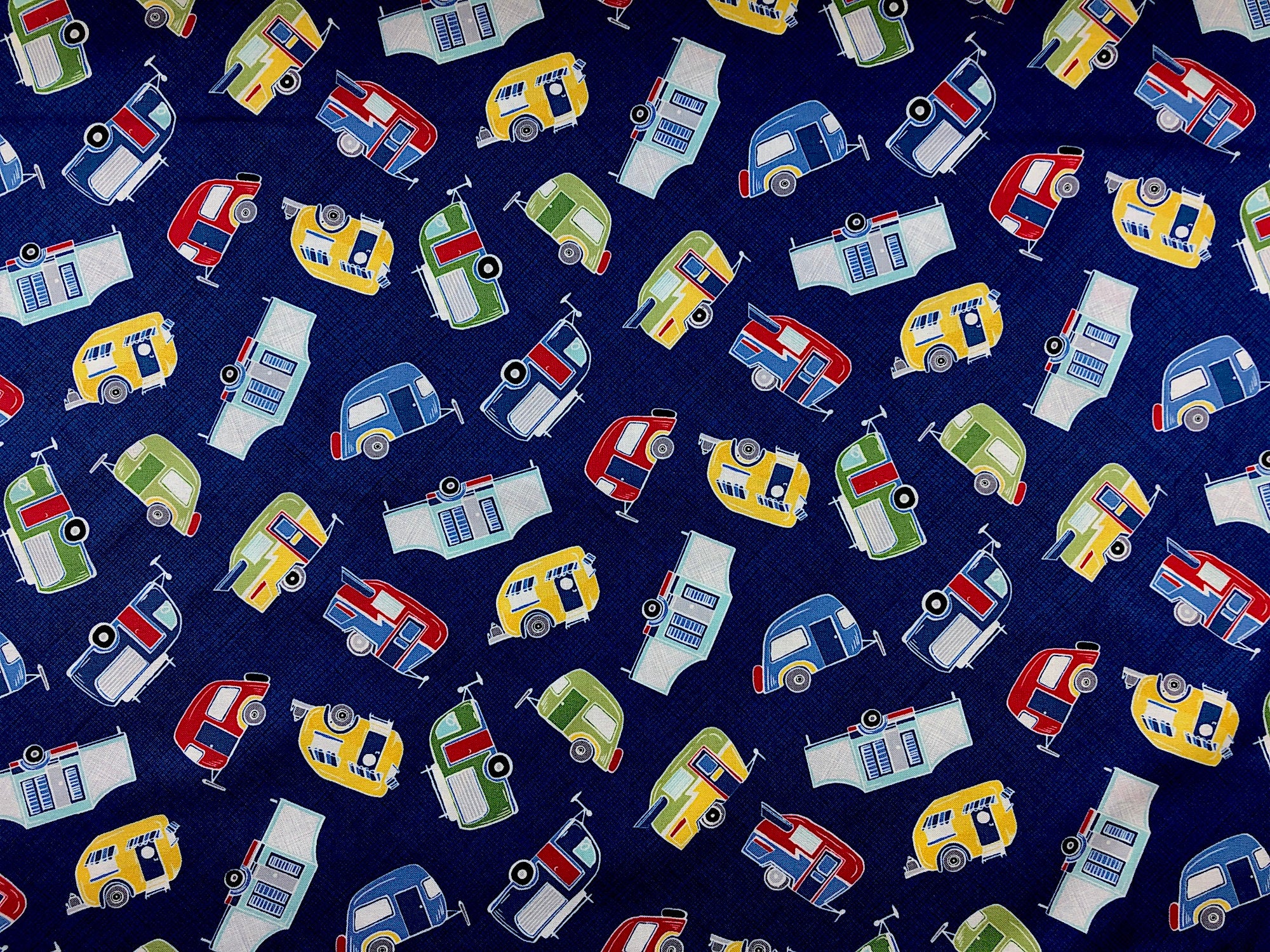 This blue fabric is covered with white, yellow, blue, red and green travel trailers.