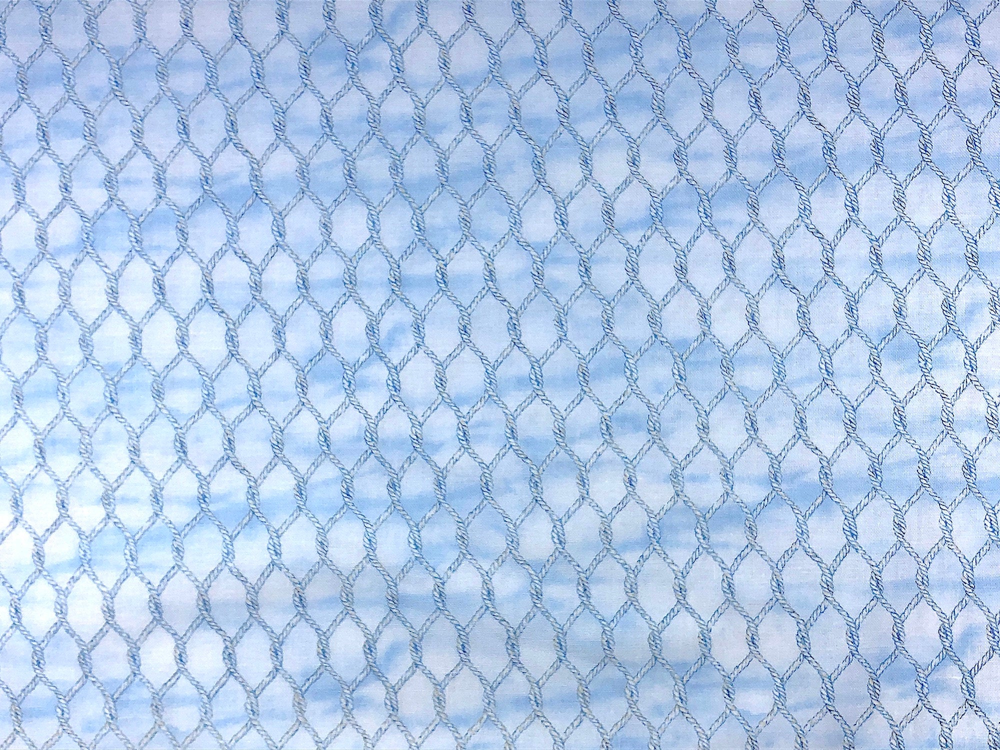 This fabric is part of the Harbor Lights collection and is covered with a rope netting