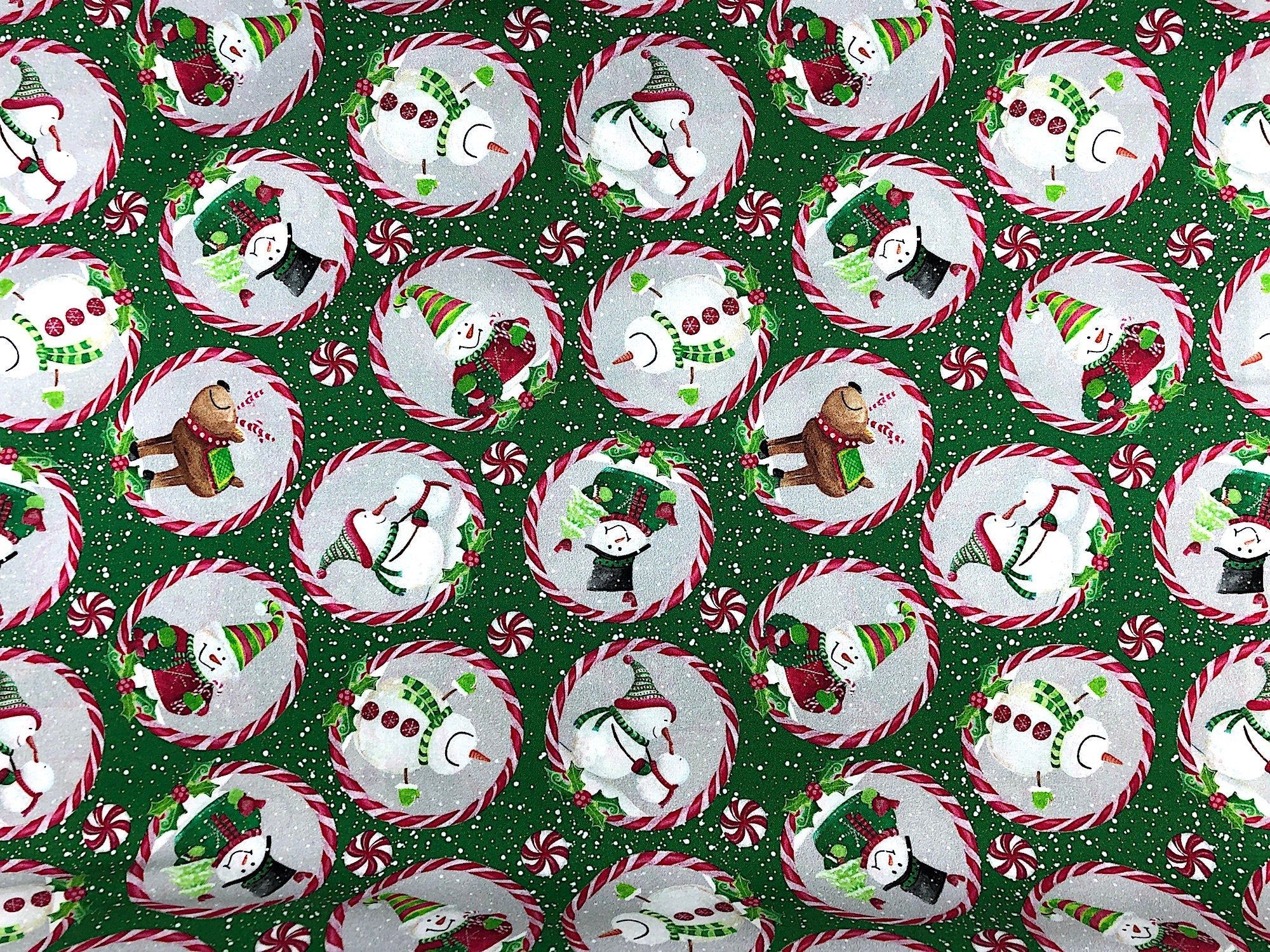 This Christmas Fabric is covered with Snowmen in different poses and outfits. They are in a circle of peppermint and there are peppermint candies scattered throughout the fabric.