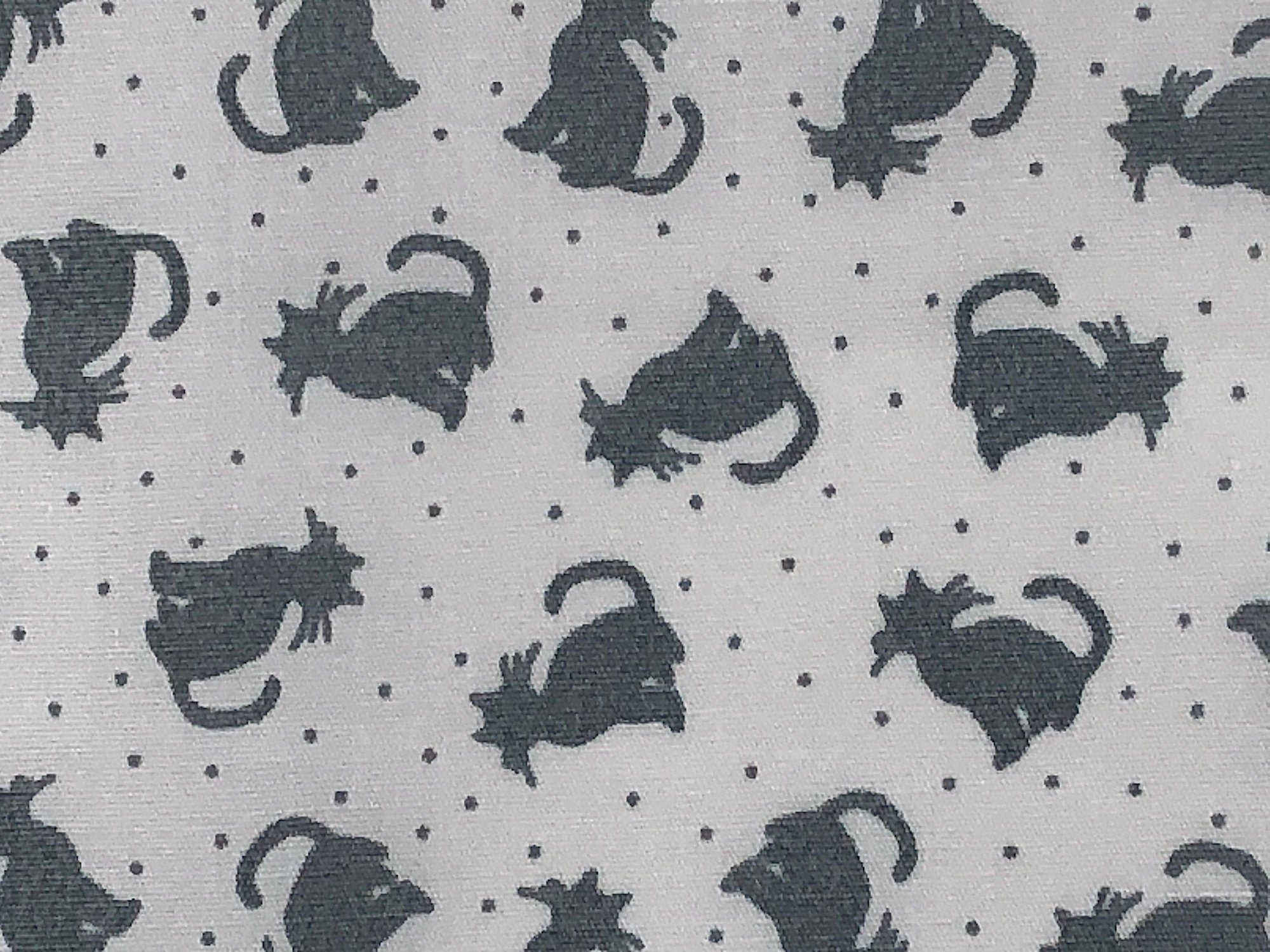 This fabric is called Tonal Cats White/Gray and is part of the Better Basics Collection. This fabric has gray cats on a white background which is also covered with small gray dots.