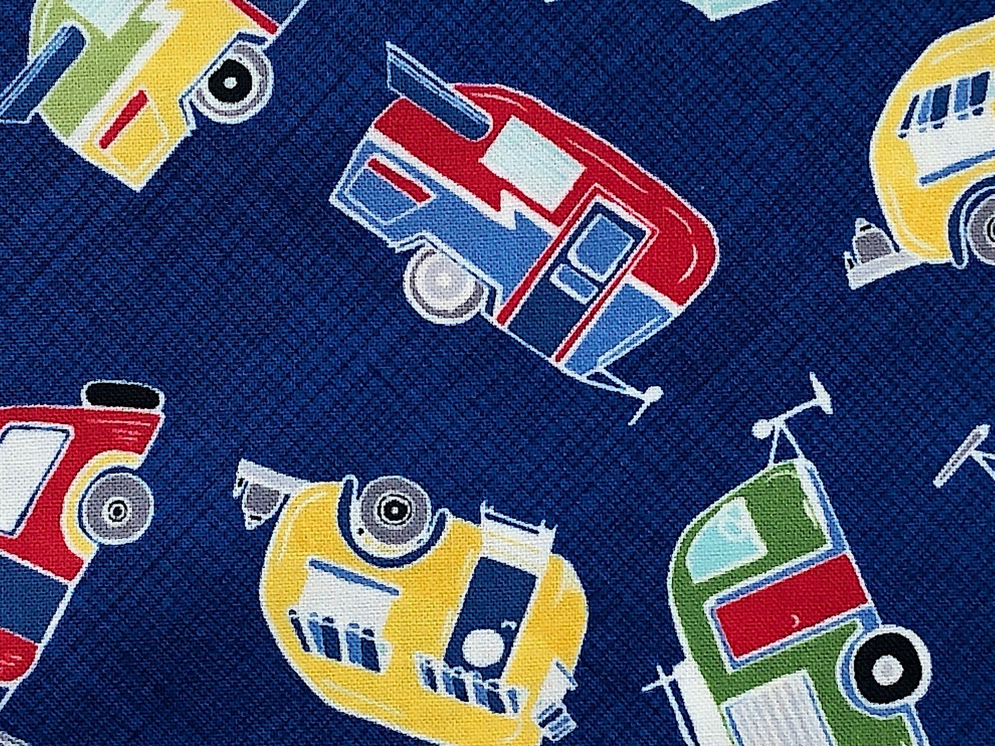 Close up of red, blue, yellow and green travel trailers.