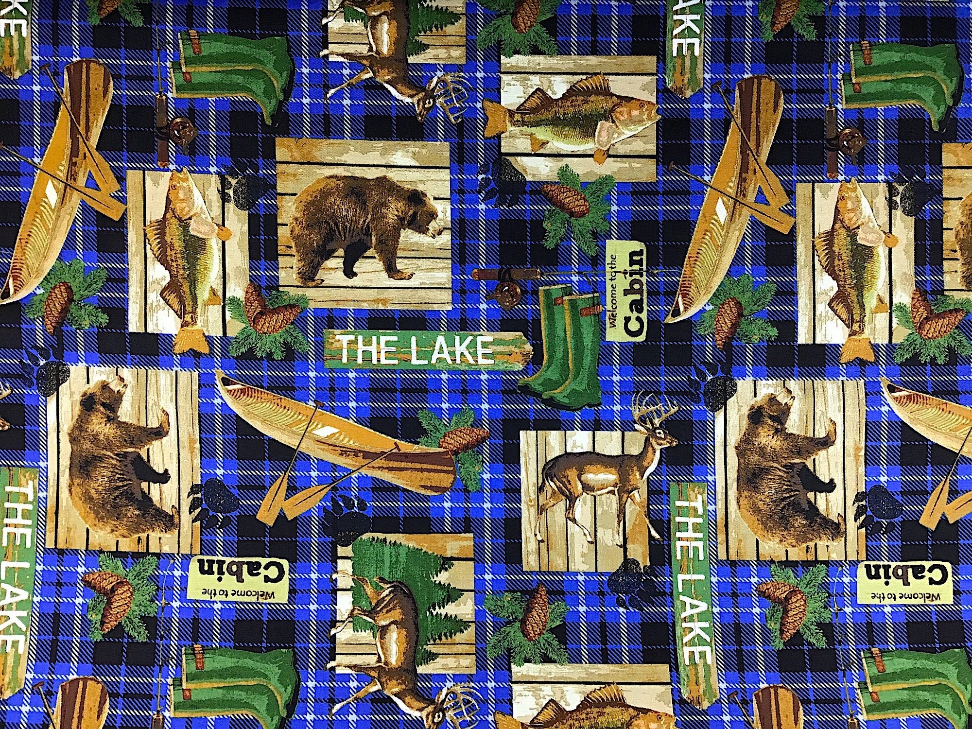 This fabric is called Lake House and is covered with canoe, bears, deer, fish pine cones and more. The background is a plaid design