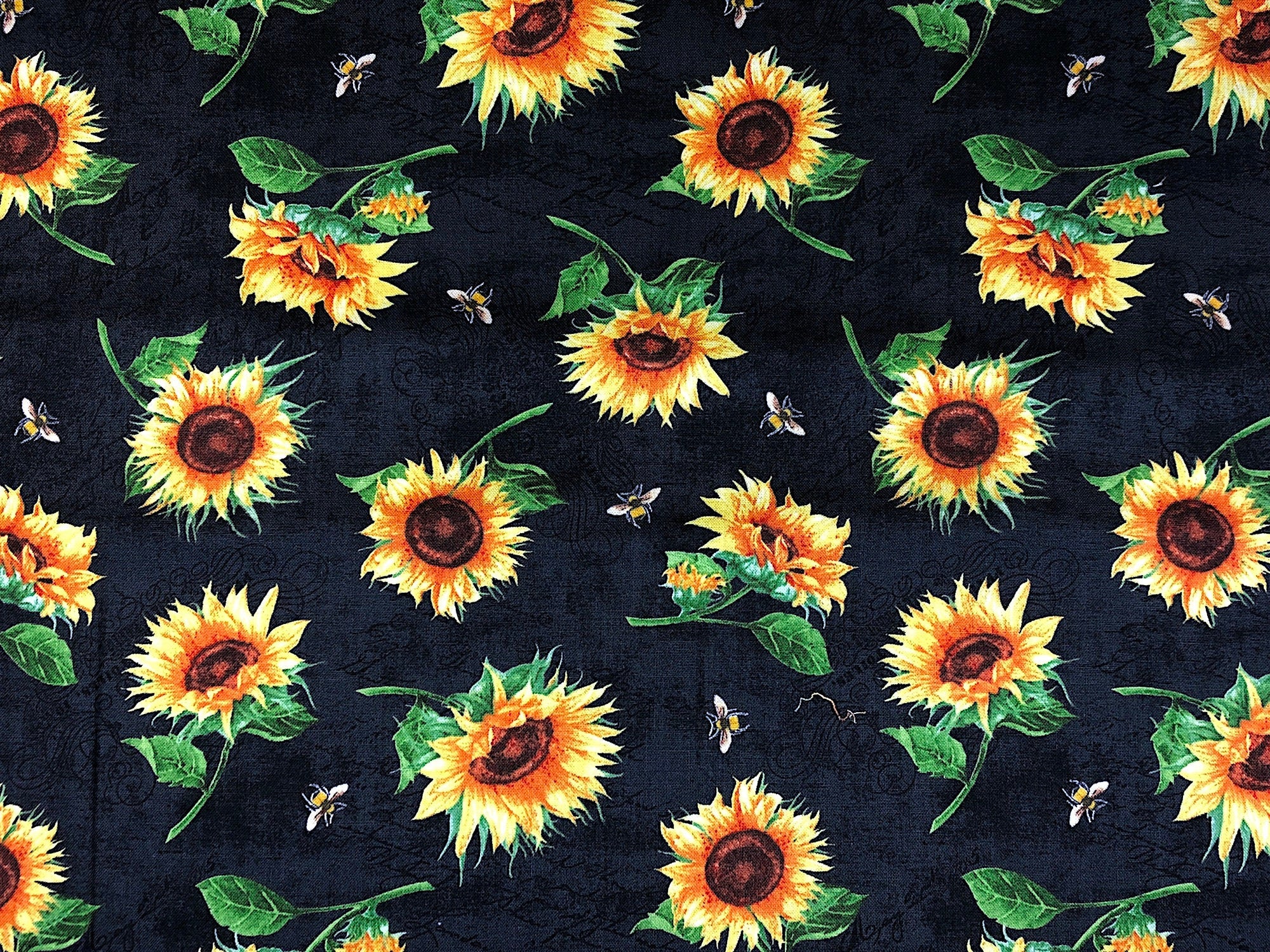 This fabric is called Sundance Meadow and is covered with sunflowers and bees. The background is black.