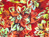 Close up of batik flowers in shades of yellow and red.