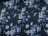 This fabric is part of the Elegant Blooms collection and is covered with blue flowers. The background is a dark blue