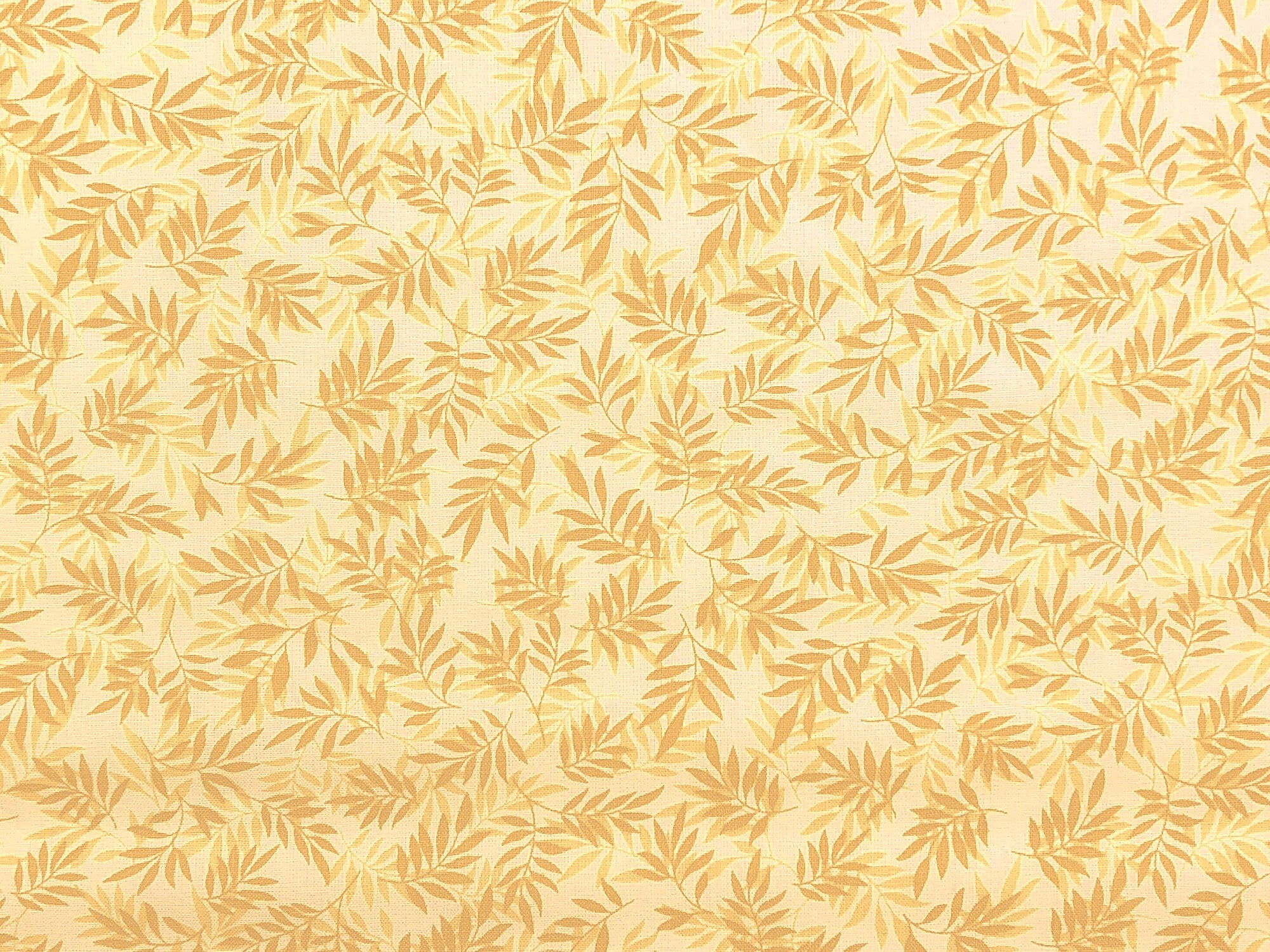 This fabric is called Sweden Vineyard and is covered with beige leaves. The background is very light yellow cream color