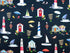 Dark blue fabric covered with lighthouses, beach chairs and umbrellas, sail boats and more.