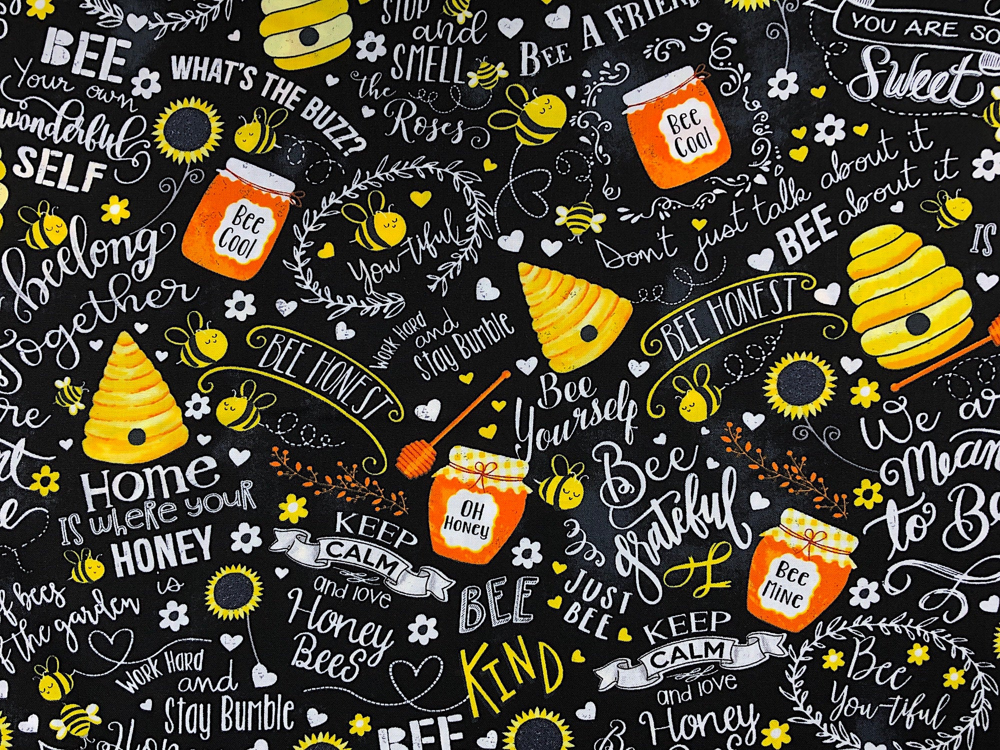 This fabric is a called Busy Bees Chalk Words. It is covered with bees, hives and jars of honey. It also has sayings such as Bee your own wonderful self, we belong together, bee honest, be yourself and more. The background is black
