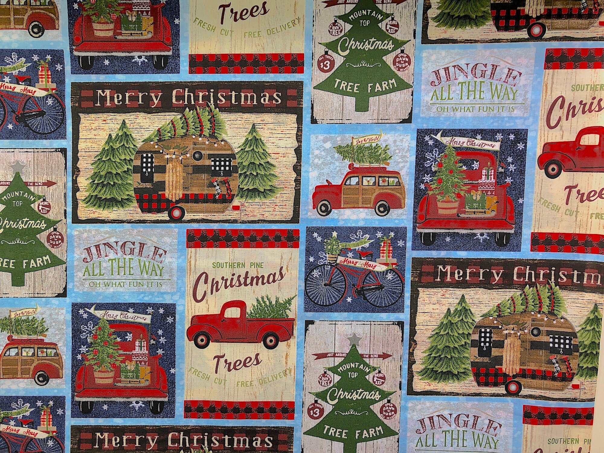 This fabric is called Jingle all the way Christmas on the road. It is covered with red trucks hauling Christmas trees, travel trailers with trees on top and Christmas sayings. Some of the sayings include Jingle all the way oh what fun it is, Southern pine Christmas trees, Merry Christmas and more.