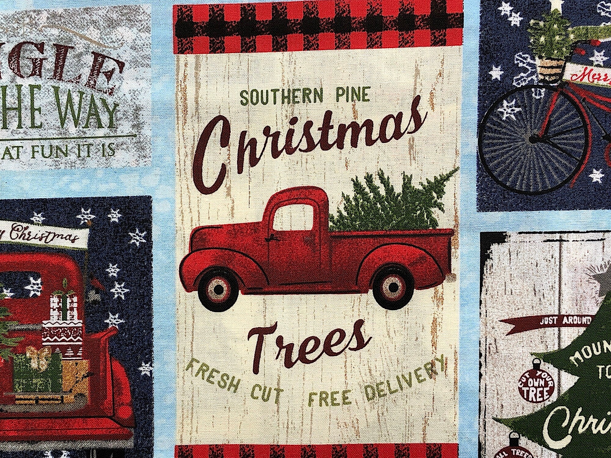 Close up of a red truck with a tree in the back and the words southern pine, Christmas Trees fresh cut free delivery.