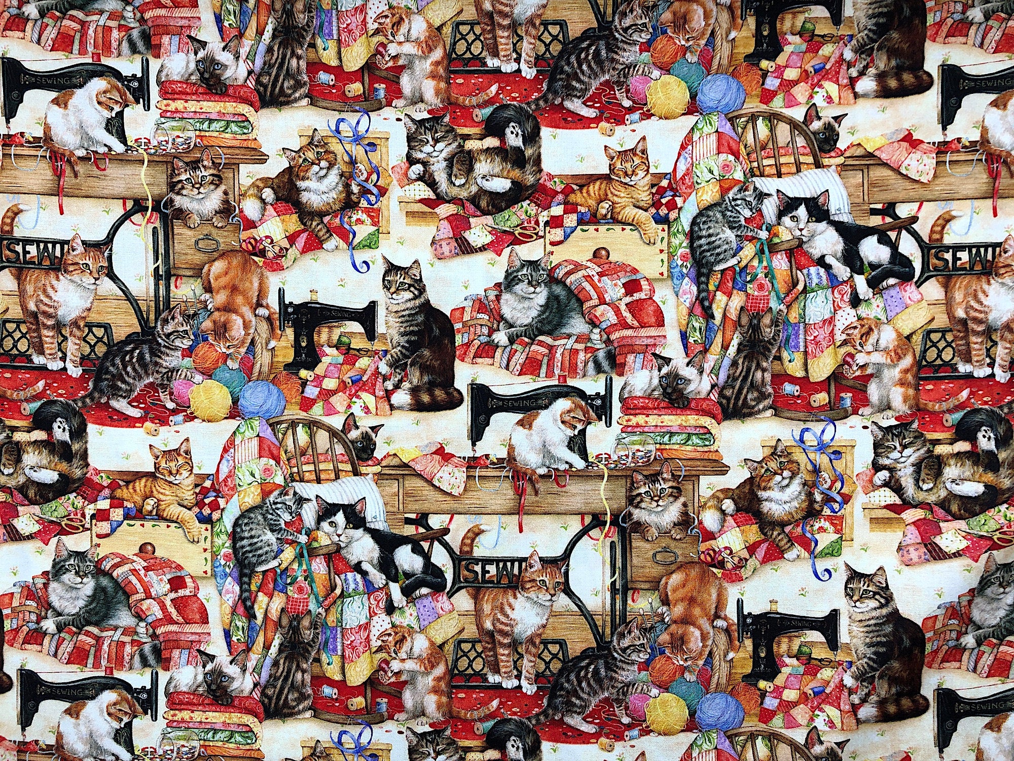 This fabric is called Sewing Buddies and is covered with sewing machines and cats. Some of the cats are sitting on quilts, others are playing in a pile of yarn.