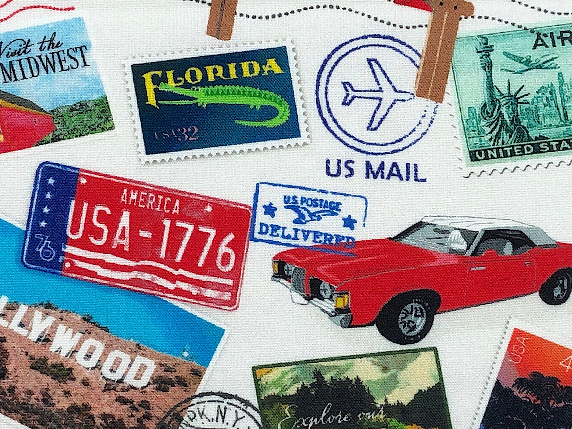 Close up of a red car, license plates and stamps.