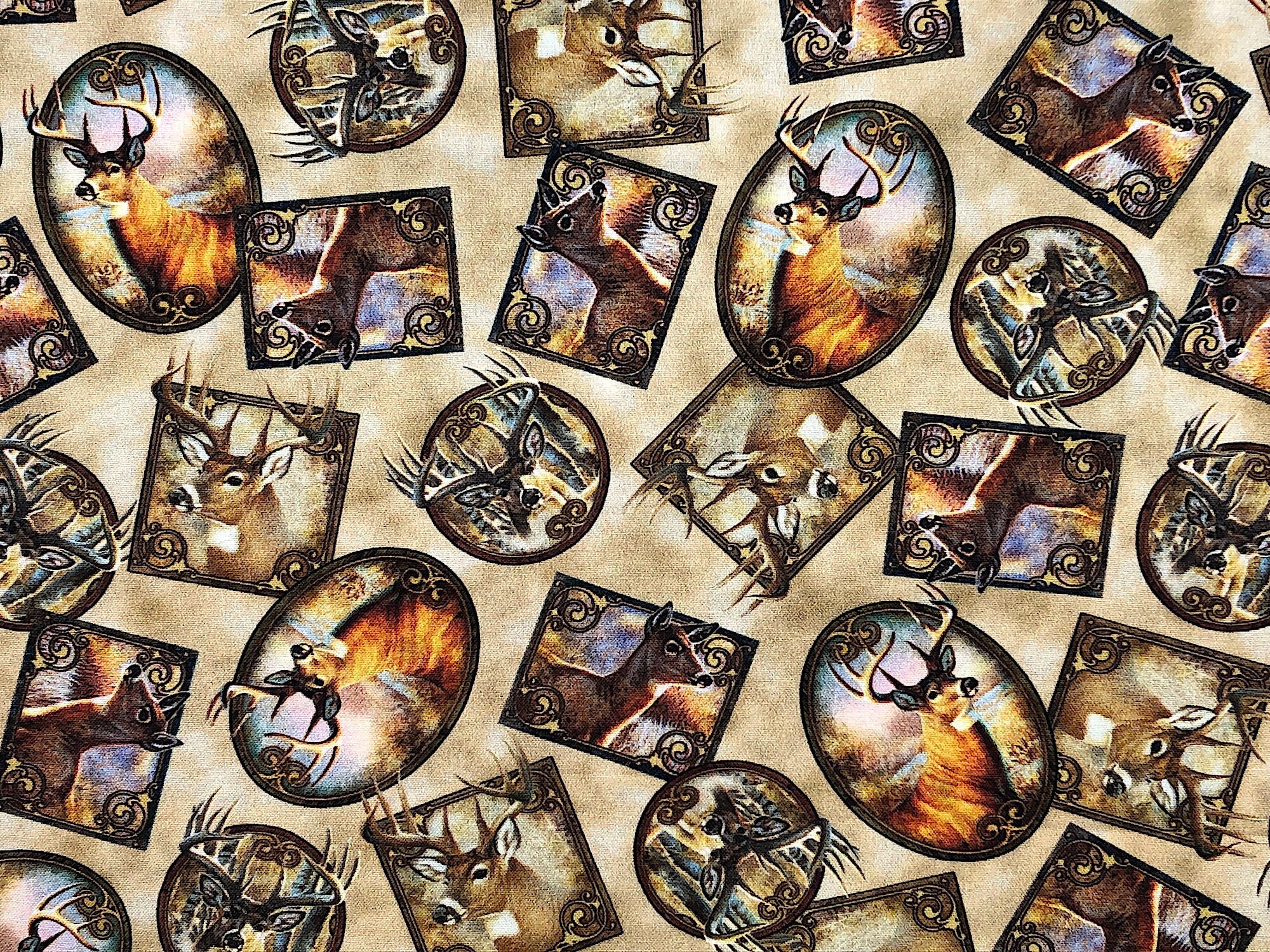 This tan fabric is called Deer Meadow and is covered with deer in different poses inside of picture frames.