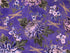 Purple cotton fabric covered with hydrangeas and dragonflies.